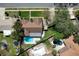 Aerial view of a home with a pool, lush trees, and well-manicured landscaping at 207 Pembrook Pl, Longwood, FL 32779