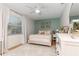 Cozy bedroom featuring natural light, with a plush white rug, bed, and modern decor at 207 Pembrook Pl, Longwood, FL 32779