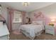 Adorable bedroom with pink accents, featuring a comfortable bed and matching nightstand at 207 Pembrook Pl, Longwood, FL 32779