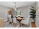 Dining room features a modern chandelier, plantation shutters, and neutral tones, perfect for intimate dining experiences at 207 Pembrook Pl, Longwood, FL 32779