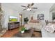 Inviting living room with wood floors, shiplap walls, and a cozy fireplace, offering a relaxed and stylish living space at 207 Pembrook Pl, Longwood, FL 32779