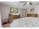 Bedroom with wood furniture, TV, and soft blue bedding, creating a comfortable and relaxing retreat at 207 Pembrook Pl, Longwood, FL 32779