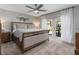 Serene primary bedroom featuring a king bed, neutral tones, and French doors leading to an outdoor patio at 207 Pembrook Pl, Longwood, FL 32779