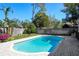 Inviting pool area with a brick-paved patio and lush tropical landscaping for outdoor enjoyment at 207 Pembrook Pl, Longwood, FL 32779