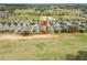 Aerial view of the property showing the house, backyard, and surrounding neighborhood with golf course views at 2212 Antilles Club Dr, Kissimmee, FL 34747