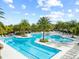 Stunning community pool surrounded by palm trees and lounge chairs at 2212 Antilles Club Dr, Kissimmee, FL 34747