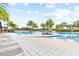 Stunning community pool featuring palm trees, lounge chairs, and ample space for relaxation and recreation at 2212 Antilles Club Dr, Kissimmee, FL 34747