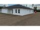 Newly constructed home featuring white stucco and dark roof with freshly seeded backyard at 2293 Sw 178Th Lane Rd, Ocala, FL 34473