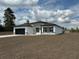 Newly built single-story home showcasing a two-car garage and a well manicured lawn at 2293 Sw 178Th Lane Rd, Ocala, FL 34473