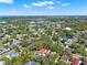 Aerial view showing a residential neighborhood with mature trees and a view of a pond in the distance at 234 N Lakeview Ave, Winter Garden, FL 34787