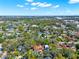 Aerial view showing a residential neighborhood with mature trees and a view of a pond in the distance at 234 N Lakeview Ave, Winter Garden, FL 34787