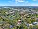 An aerial view showcases a neighborhood with beautiful trees and a home with a swimming pool at 234 N Lakeview Ave, Winter Garden, FL 34787