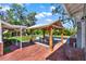 Inviting backyard featuring a covered outdoor dining area, pool, and lush landscaping at 234 N Lakeview Ave, Winter Garden, FL 34787