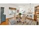 Elegant dining area featuring a wood table, chandelier, and view into the bright, modern kitchen at 234 N Lakeview Ave, Winter Garden, FL 34787