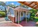 Charming guesthouse with a covered porch, brick accents, and lush landscaping at 234 N Lakeview Ave, Winter Garden, FL 34787