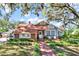 Charming home with brick accents, manicured lawn, and inviting front porch seating at 234 N Lakeview Ave, Winter Garden, FL 34787