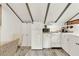 Charming kitchen featuring white cabinetry, modern appliances, and a unique ceiling with exposed beams at 234 N Lakeview Ave, Winter Garden, FL 34787