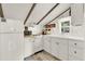 Bright kitchen featuring white cabinetry, modern appliances, and a window overlooking the yard at 234 N Lakeview Ave, Winter Garden, FL 34787