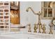 Close-up of the farmhouse-style sink with brass fixtures and marble countertop at 234 N Lakeview Ave, Winter Garden, FL 34787