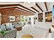 Spacious living room featuring exposed beam ceilings, brick wall, and large windows at 234 N Lakeview Ave, Winter Garden, FL 34787