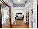 Stylish main bedroom with blue and white wallpaper, hardwood floors, and closet space at 234 N Lakeview Ave, Winter Garden, FL 34787