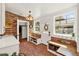 Bright mudroom with brick flooring and walls, built-in benches, and a decorative glass front door at 234 N Lakeview Ave, Winter Garden, FL 34787