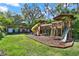 Backyard featuring a large wooden playground and four covered golf cart parking spots at 234 N Lakeview Ave, Winter Garden, FL 34787