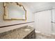 Bright bathroom featuring granite countertops, a large framed mirror, and a shower-tub combination at 2525 Cr 543, Sumterville, FL 33585