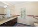 Bright bathroom featuring granite counters, tile floors, and a window providing natural light at 2525 Cr 543, Sumterville, FL 33585