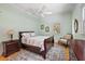 Cozy bedroom featuring light green walls, a ceiling fan, hardwood floors and a decorative accent rug at 2525 Cr 543, Sumterville, FL 33585