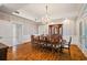 Formal dining room featuring a chandelier, wooden table with seating for ten, and beautiful hardwood floors at 2525 Cr 543, Sumterville, FL 33585