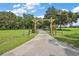 Long concrete driveway leading to a gated entry and grassy pasture land at 2525 Cr 543, Sumterville, FL 33585