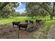 View of a grassy pasture with black cows gathered around a feeder at 2525 Cr 543, Sumterville, FL 33585