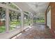 Bright sunroom offering a large window view of the manicured backyard and tiled flooring at 2525 Cr 543, Sumterville, FL 33585