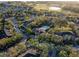 Community shot from above showing the pool, clubhouse, parking, trees, and golf course at 2600 Robert Trent Jones # 934, Orlando, FL 32835