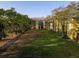 Wide angle shot of a yellow multi-story apartment building with lush lawn and mature trees at 2600 Robert Trent Jones # 934, Orlando, FL 32835