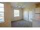 Bright living room with neutral carpet and ample natural light from a large window and glass door at 2600 Robert Trent Jones # 934, Orlando, FL 32835