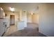 Open-concept layout showcasing the kitchen seamlessly flowing into the living area with neutral walls and carpeted floors at 2600 Robert Trent Jones # 934, Orlando, FL 32835