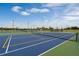 Community tennis courts with playground and picnic pavilion in a landscaped lawn on a sunny day at 2680 Gouda Dr, Apopka, FL 32703