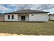 A view of the home's backyard with sliding glass doors and an AC unit at 2703 Sw 162Nd Street Rd, Ocala, FL 34473