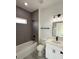 Modern bathroom featuring gray tile shower, white cabinets, and black hardware at 2703 Sw 162Nd Street Rd, Ocala, FL 34473