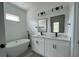 Bright bathroom with a soaking tub, double vanity, and modern black fixtures at 2703 Sw 162Nd Street Rd, Ocala, FL 34473