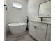 Bright bathroom featuring a soaking tub, modern vanity, and beautiful black fixtures at 2703 Sw 162Nd Street Rd, Ocala, FL 34473