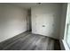 Bedroom with gray wood-look floors, double closet, and bright window at 2703 Sw 162Nd Street Rd, Ocala, FL 34473