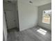 This bedroom features gray wood-look floors and a bright window at 2703 Sw 162Nd Street Rd, Ocala, FL 34473