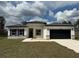 Charming single-story home featuring a stylish black garage door and attractive stone accents at 2703 Sw 162Nd Street Rd, Ocala, FL 34473