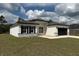 Stylish one-story home with a black roof and white exterior at 2703 Sw 162Nd Street Rd, Ocala, FL 34473