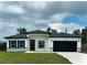 Charming single-story home with a black garage door, gray stone accents, and well-manicured lawn at 2703 Sw 162Nd Street Rd, Ocala, FL 34473