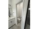 Toilet room view through doorway; features a commode, gray floors and white paint at 2703 Sw 162Nd Street Rd, Ocala, FL 34473