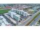 An aerial view of the white condominium building with a blue pool and a parking lot with beach views at 2727 N Atlantic Ave # 2020, Daytona Beach, FL 32118